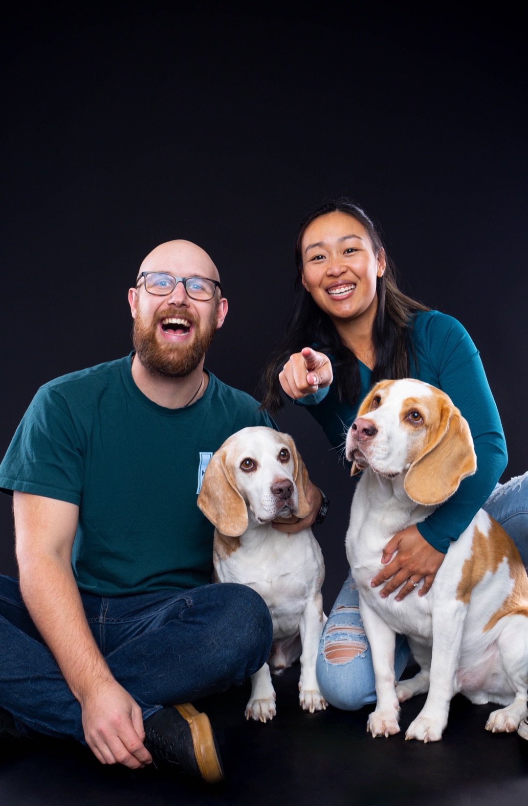 Josh and Steph, the pet photographers behind Paw Prints Melbourne, with their two beagles in the studio